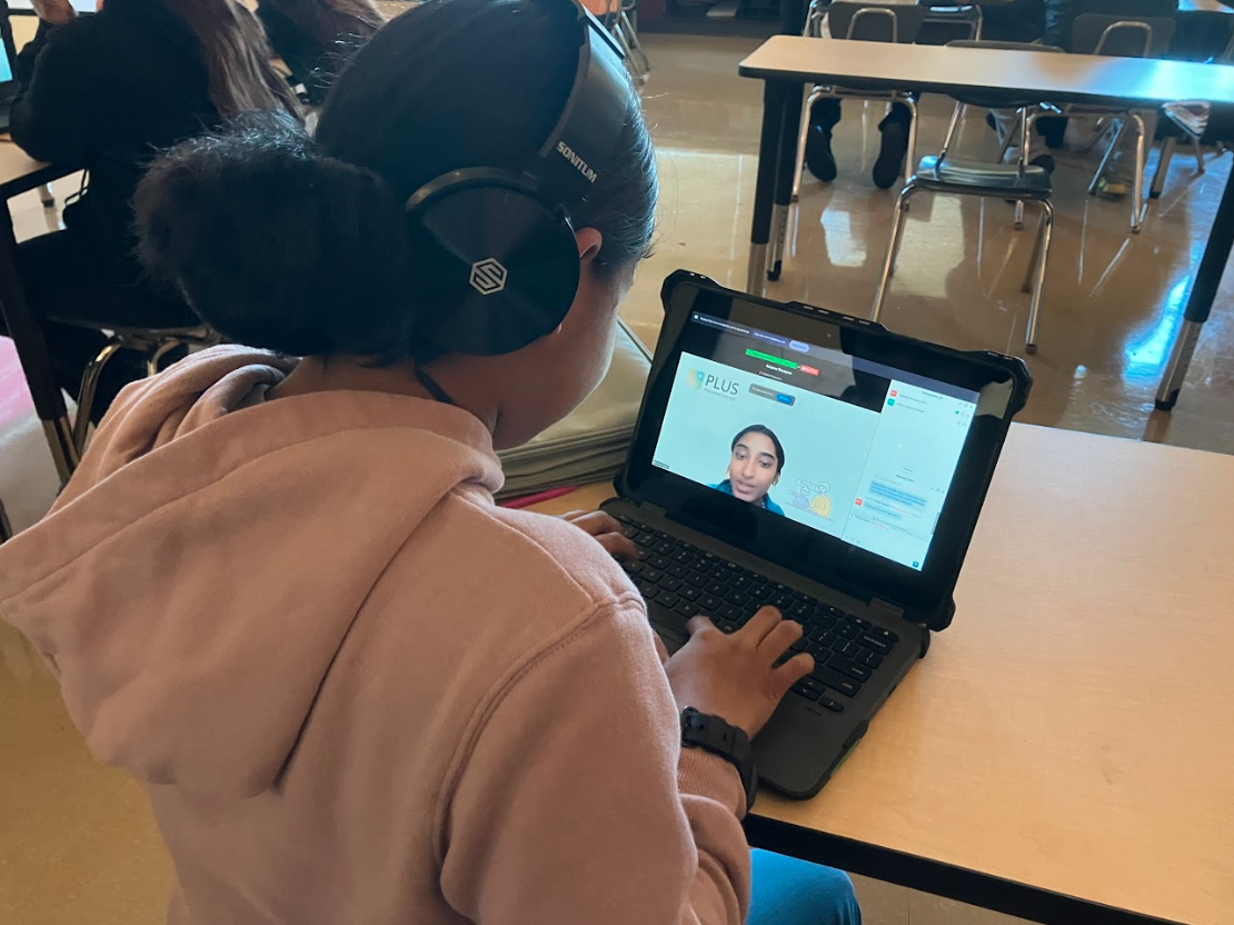 Student on a video call with a tutor on a laptop